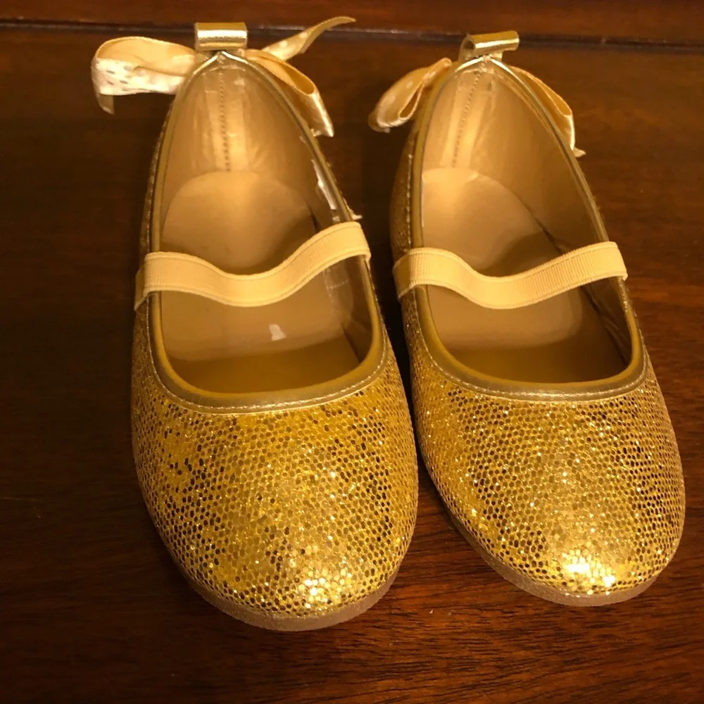 Toddler Girl’s Yellow Gold glitter dress shoes with ribbon bow on back s…